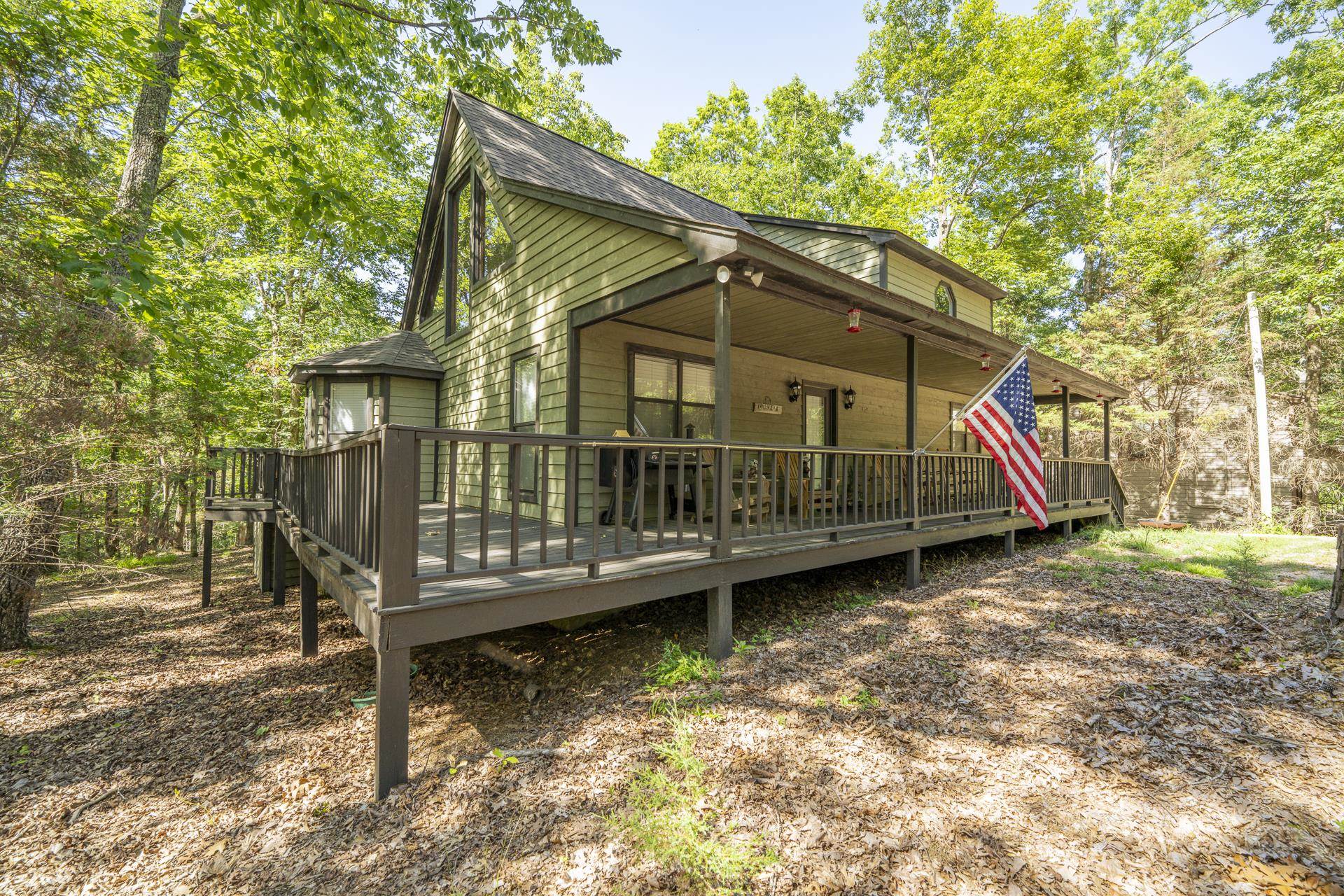 435 Murray Lane Counce, TN 38326 - Photo 4 of 34 Wood-sided residence featuring a covered front porch and expansive wrap-around deck