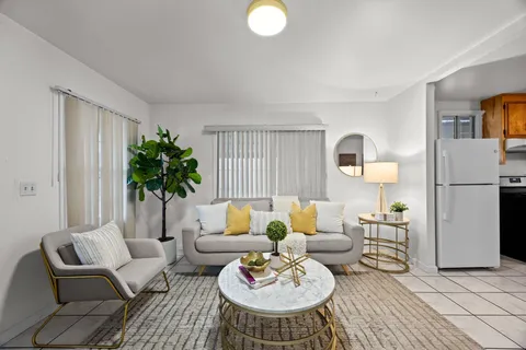 a living room with furniture and a potted plant