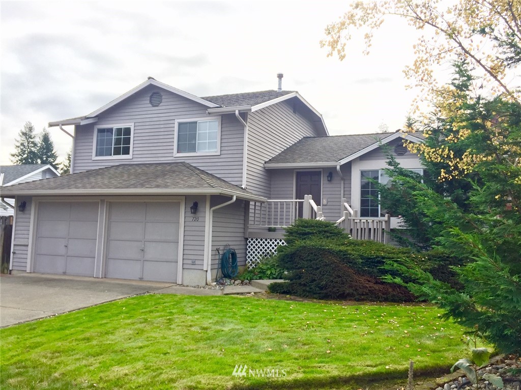 720 213th Street Southeast Bothell, WA 98021 - Photo 1 of 1 a front view of a house with a garden and plants