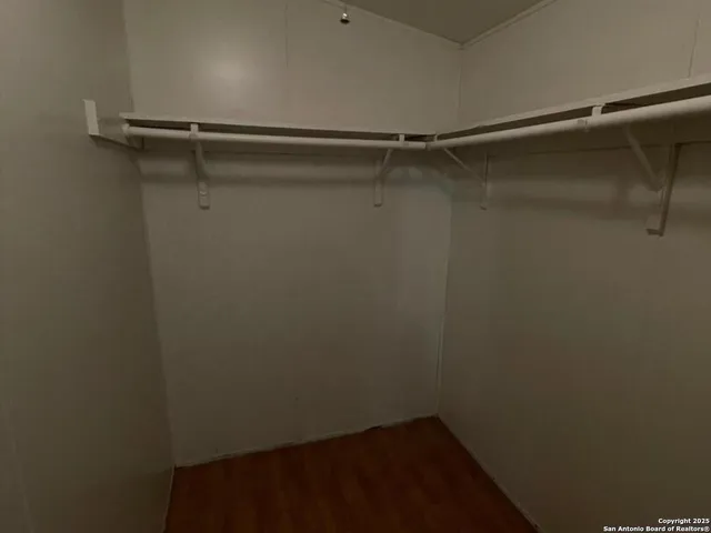 a bathroom with a granite countertop sink and a toilet