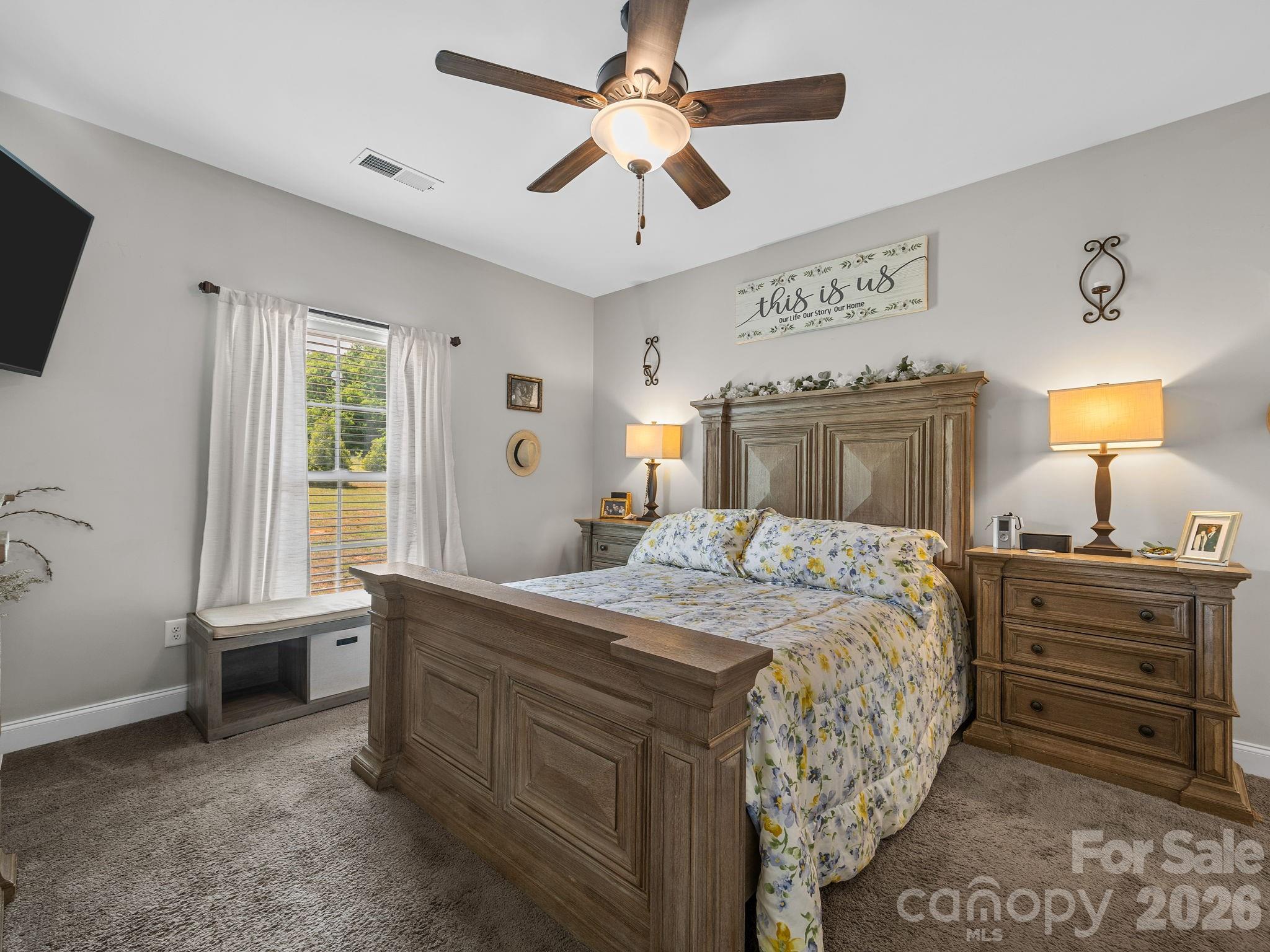 1076 McSwain Road Chesnee, SC 29323 - Photo 17 of 36 a bedroom with a bed and a chandelier