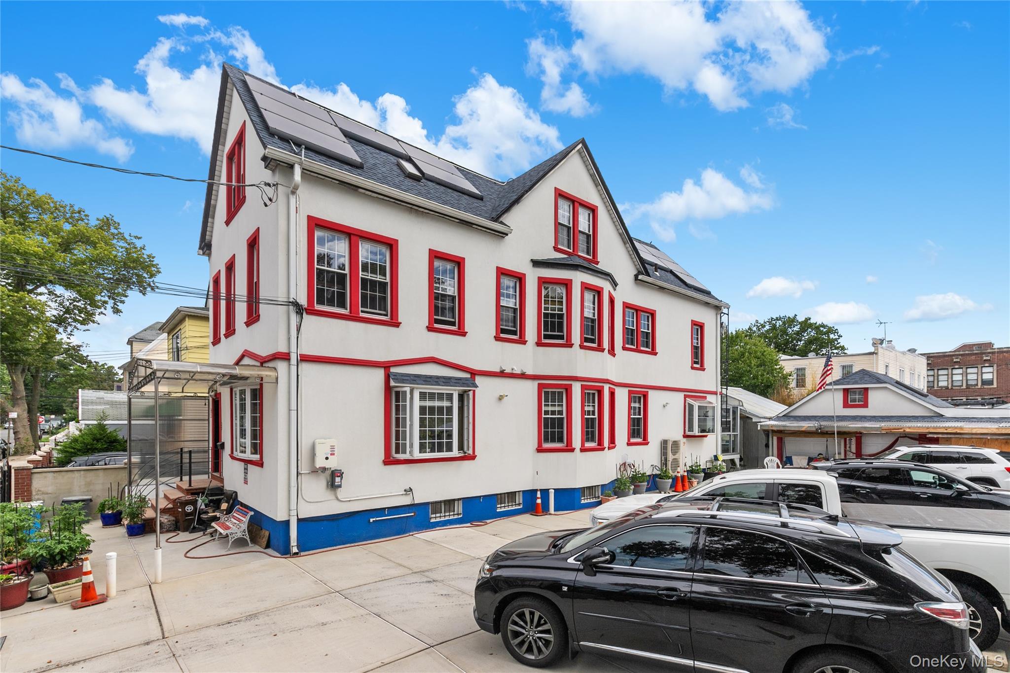 8713 135th Street, Unit 3 Queens, NY 11418 - Photo 2 of 22 a front view of a residential apartment building with a yard
