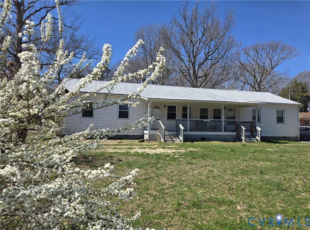 a view of a house with backyard porch and sitting area