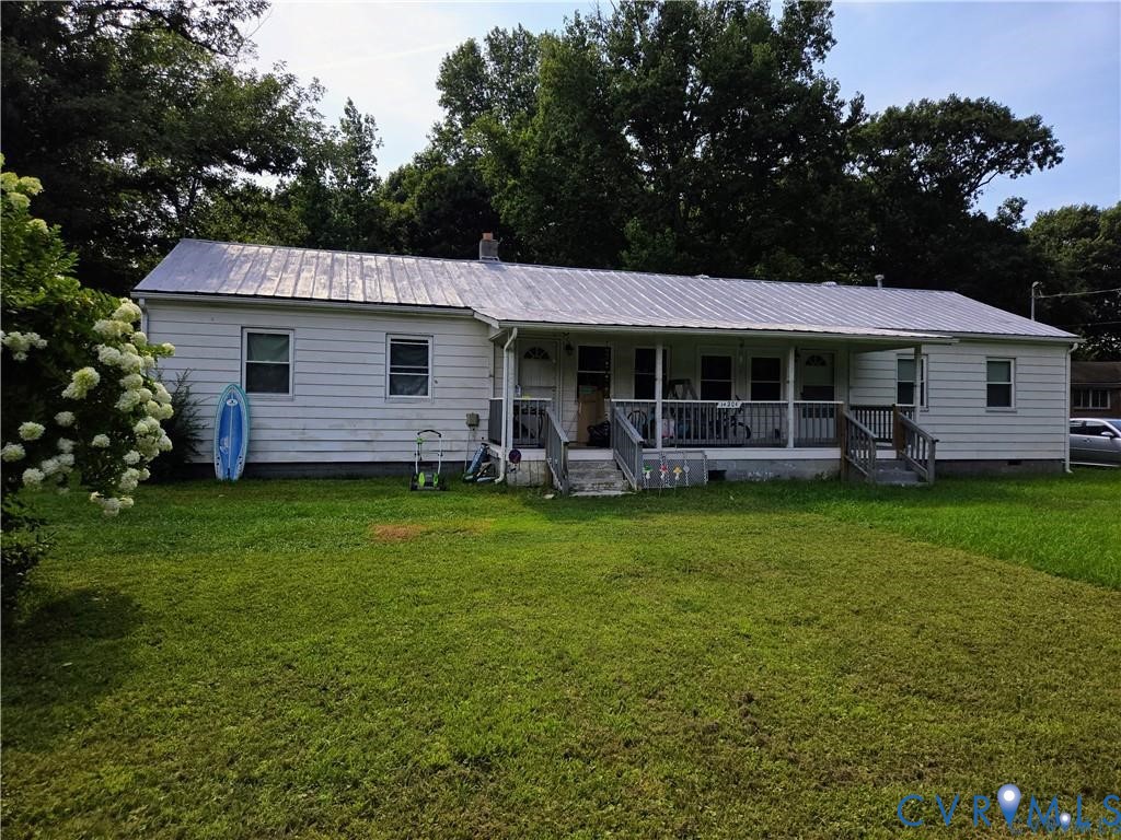 14204 Arwood Road Disputanta, VA 23842 - Photo 3 of 12 a front view of a house with a garden