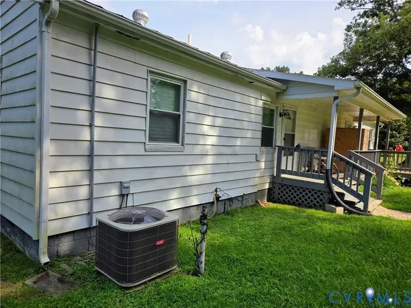 a view of backyard with barbeque grill and a wooden fence