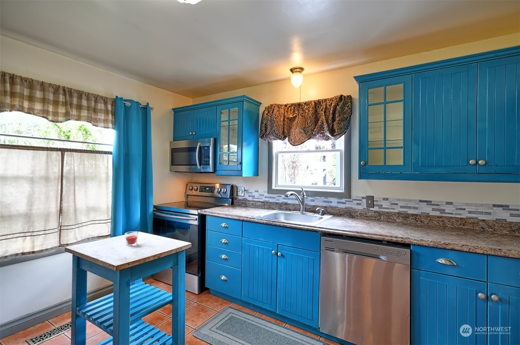 330 North Cabot Road Everett, WA 98203 - Photo 6 of 31 a kitchen with a sink a window and chairs