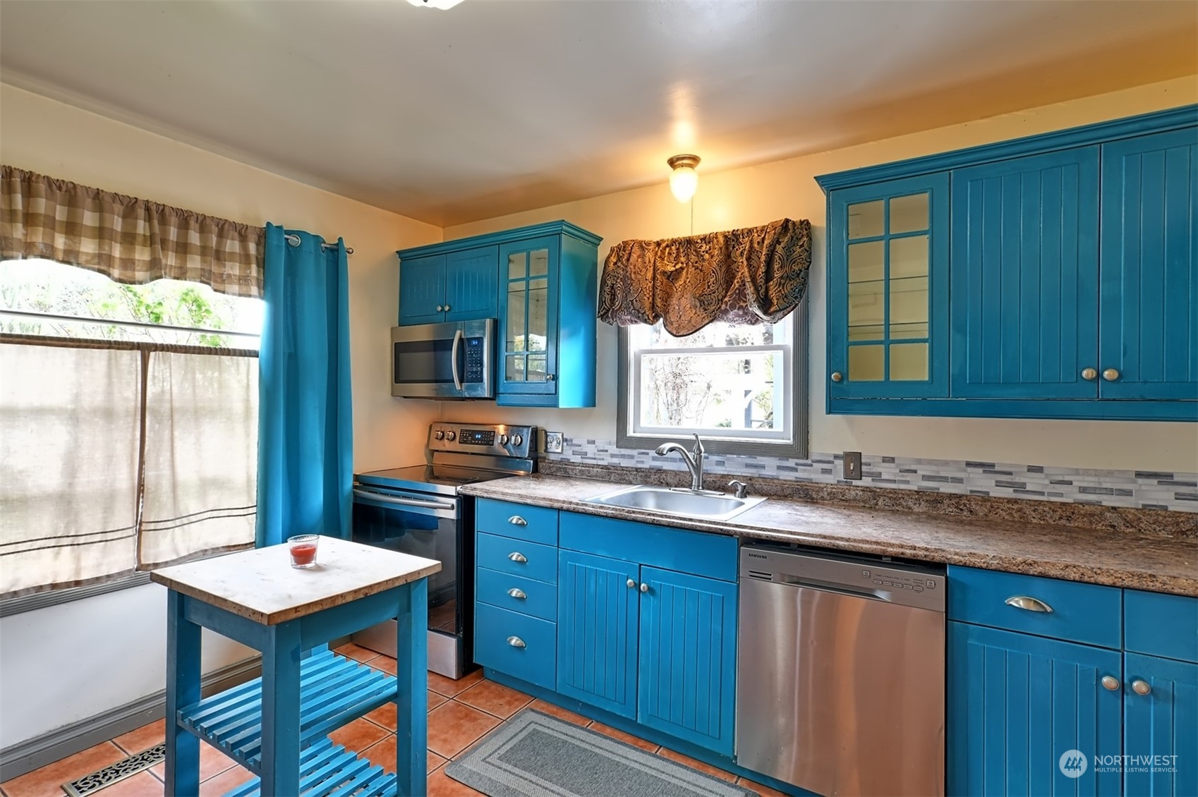 330 North Cabot Road Everett, WA 98203 - Photo 7 of 31 a kitchen with a sink a window and chairs