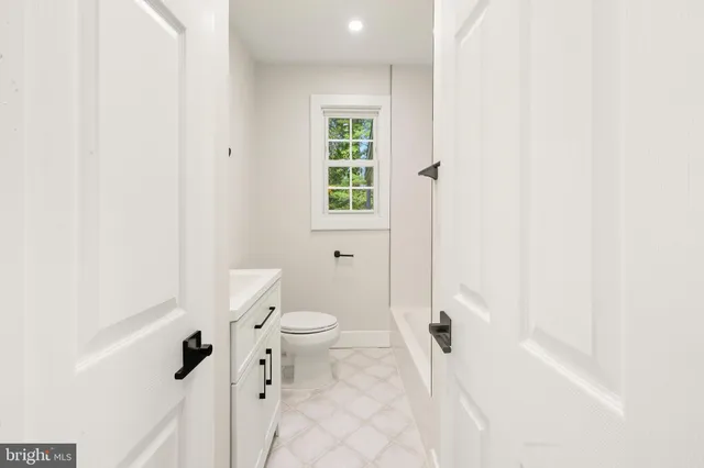 a bathroom with a toilet a sink and a shower