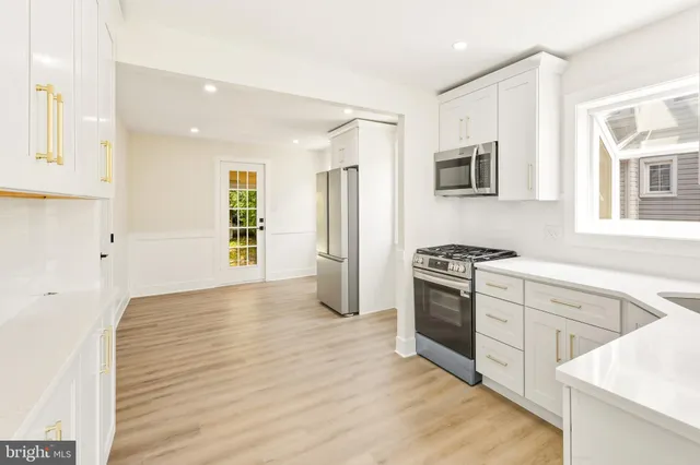 a kitchen with stainless steel appliances granite countertop a stove and a refrigerator