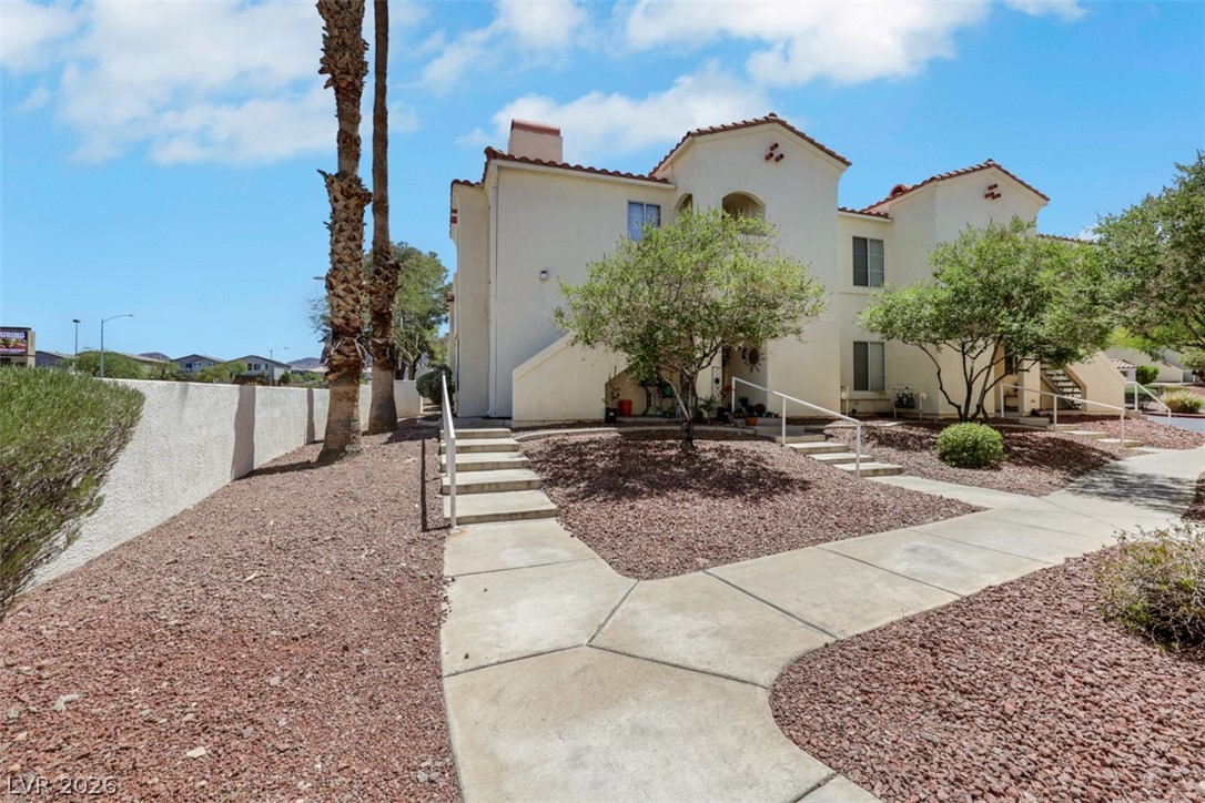698 South Racetrack Road, Unit 1614 Henderson, NV 89015 - Photo 5 of 35 A well-maintained desert landscape frames this multi-level residential building.