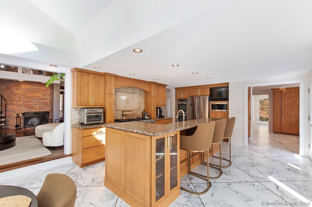 5 Mohawk Lane Woodbridge, CT 06525 - Photo 11 of 28 a view of a dining room with furniture a kitchen and chandelier