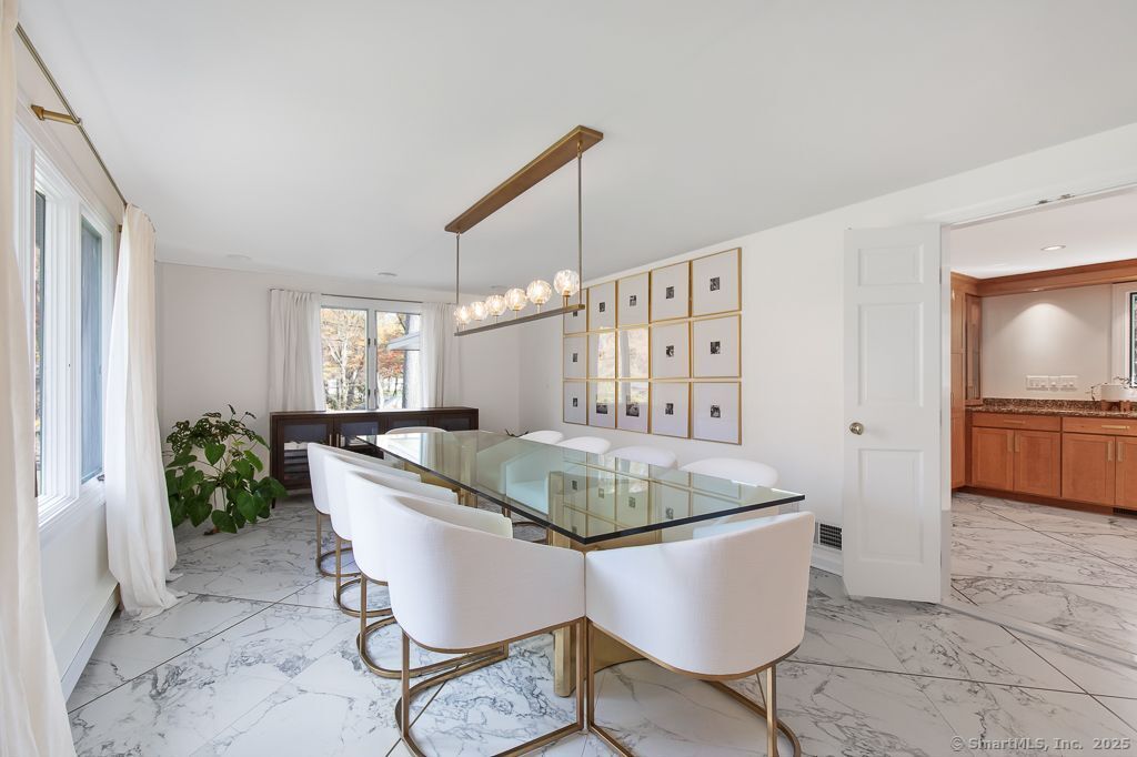 5 Mohawk Lane Woodbridge, CT 06525 - Photo 13 of 28 a living room with table and chairs