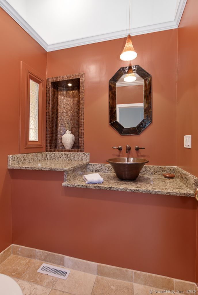 5 Mohawk Lane Woodbridge, CT 06525 - Photo 21 of 28 a bathroom with a sink and a mirror
