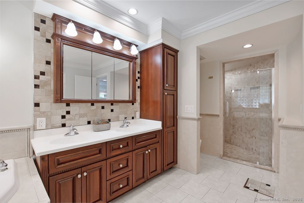5 Mohawk Lane Woodbridge, CT 06525 - Photo 22 of 28 a bathroom with a double vanity sink mirror double and shower