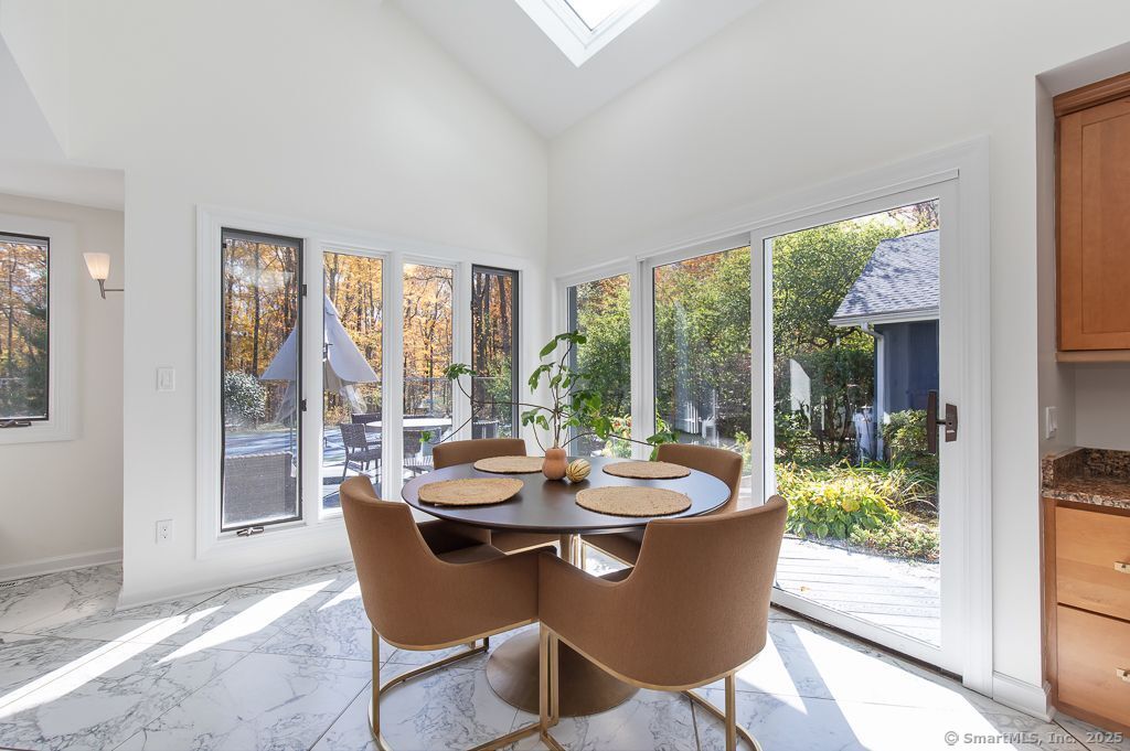 5 Mohawk Lane Woodbridge, CT 06525 - Photo 8 of 28 a dining room with furniture a chandelier and wooden floor