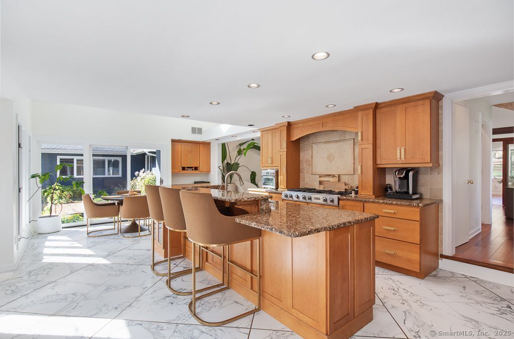 5 Mohawk Lane Woodbridge, CT 06525 - Photo 9 of 28 a kitchen with stainless steel appliances granite countertop a stove a sink and a refrigerator