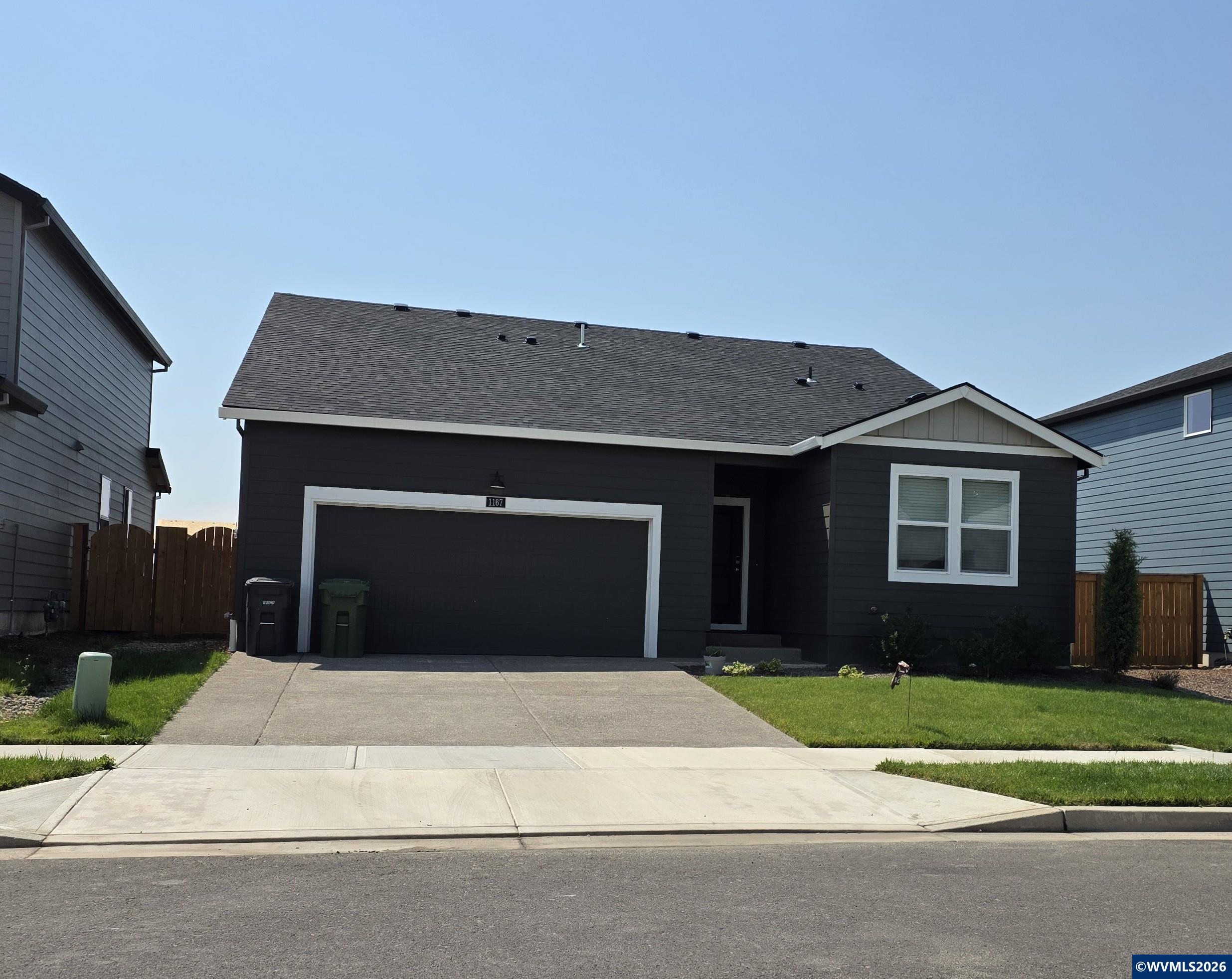 1167 Stubb Road Northeast Woodburn, OR 97071 - Photo 1 of 3 a front view of a house with a yard and garage