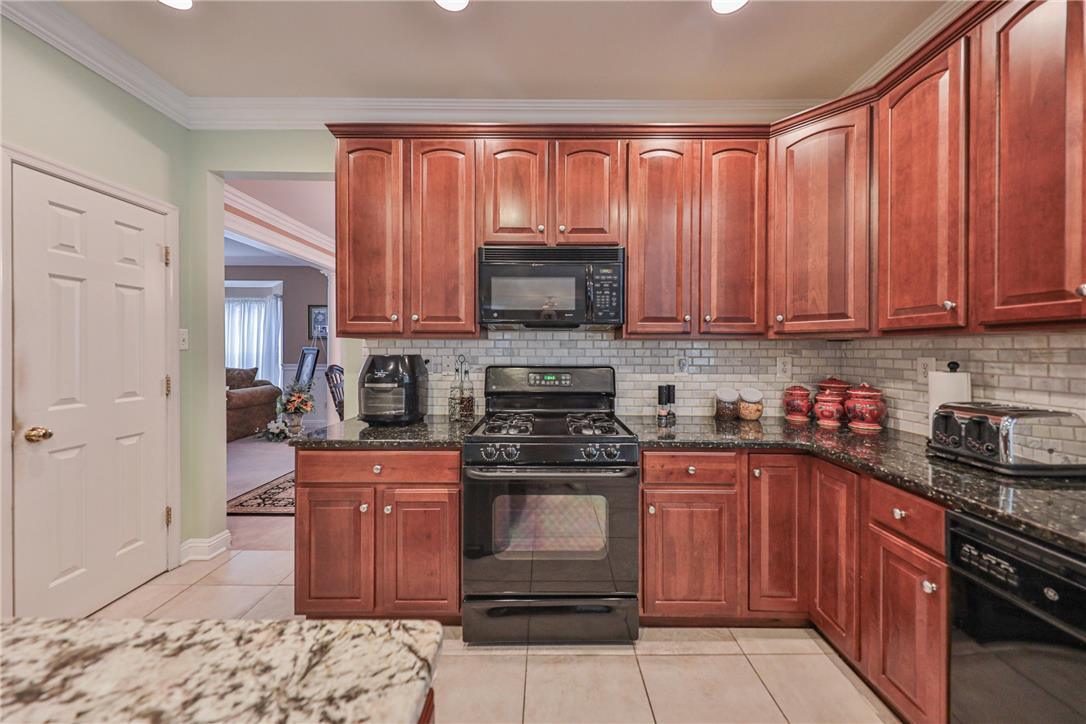 138 Clover Hollow Road Easton, PA 18045 - Photo 19 of 95 A well-appointed kitchen features rich wood cabinetry and ample counter space for culinary endeavors.