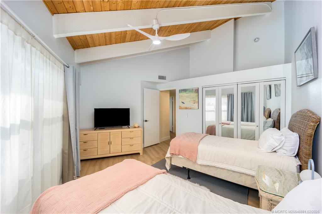 2355 Northeast Ocean Boulevard, Unit 19B Stuart, FL 34996 - Photo 11 of 20 a bedroom with a bed and a flat screen tv