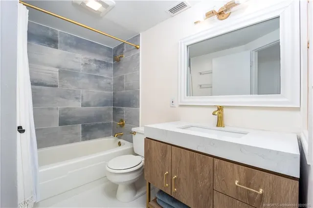 a bathroom with a sink a toilet and a bathtub