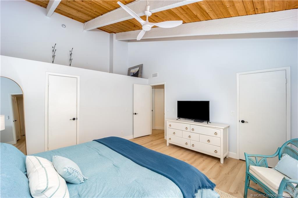 2355 Northeast Ocean Boulevard, Unit 19B Stuart, FL 34996 - Photo 15 of 20 a bedroom with a bed and a flat screen tv