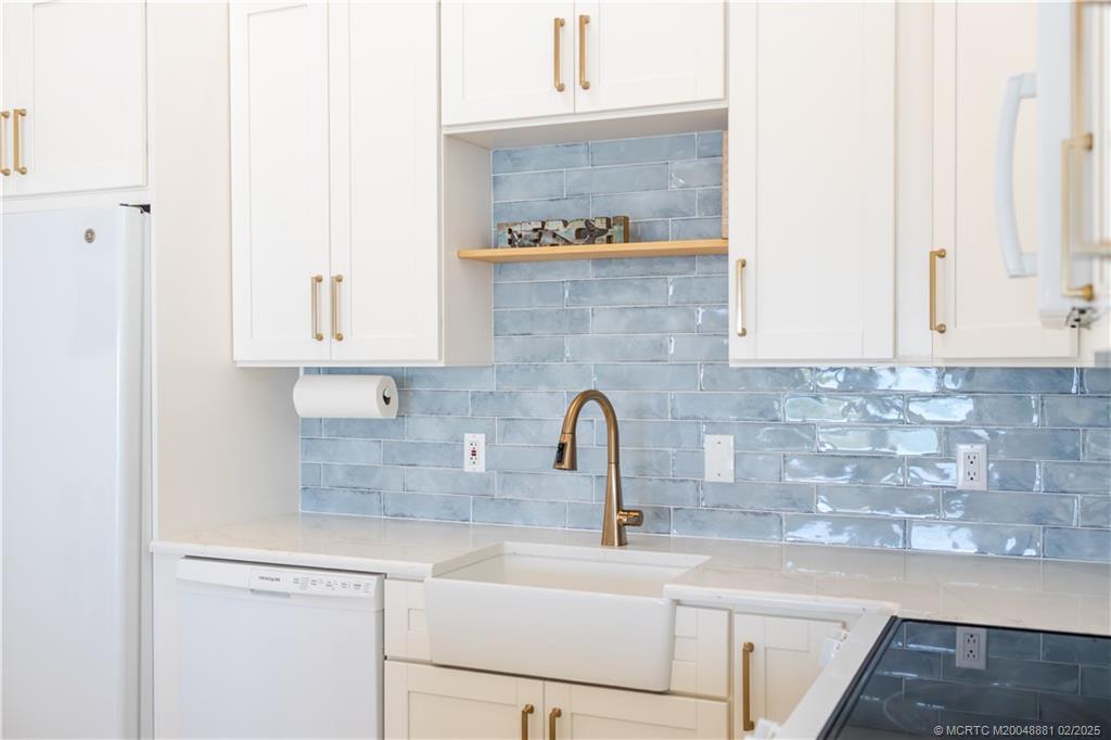 2355 Northeast Ocean Boulevard, Unit 19B Stuart, FL 34996 - Photo 4 of 20 a kitchen with stainless steel appliances granite countertop a sink a stove and cabinets