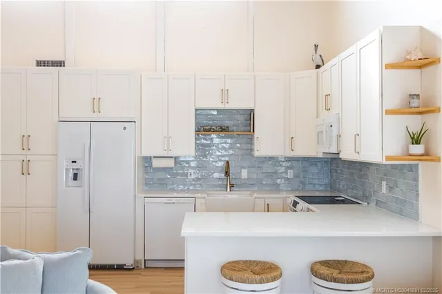 a kitchen with kitchen island cabinets and refrigerator