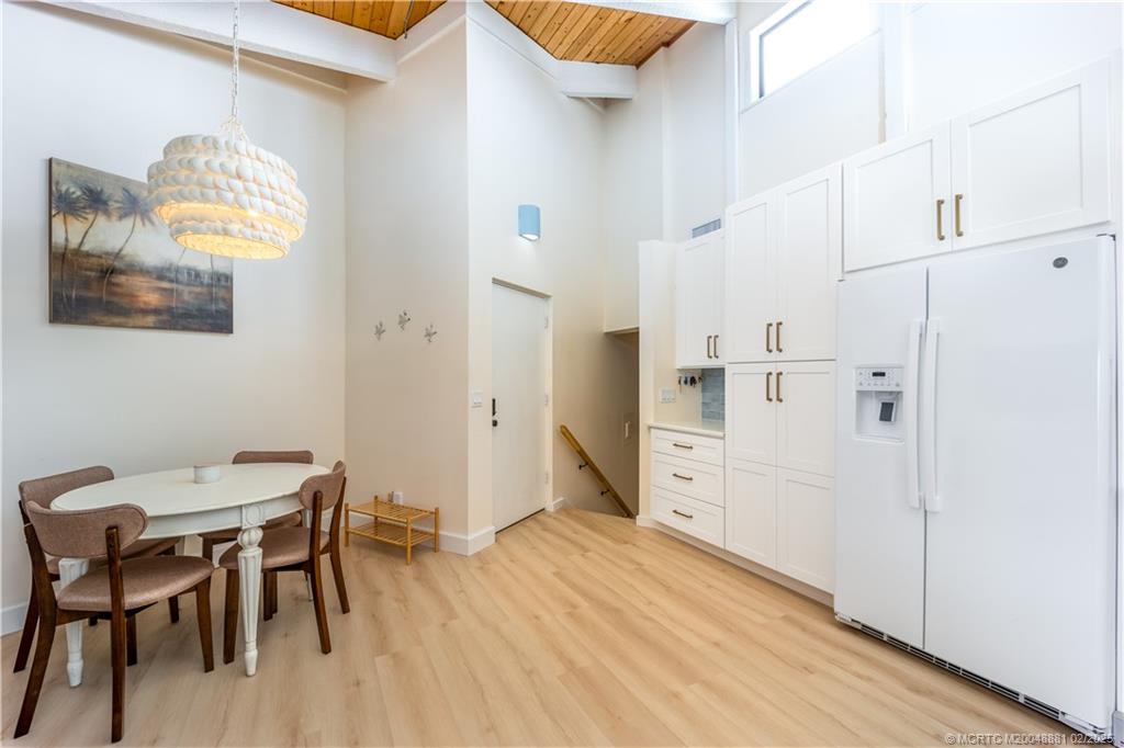 2355 Northeast Ocean Boulevard, Unit 19B Stuart, FL 34996 - Photo 8 of 20 a view of a kitchen with furniture and wooden floor