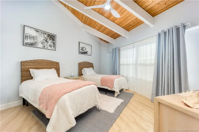 a bedroom with two beds and a window