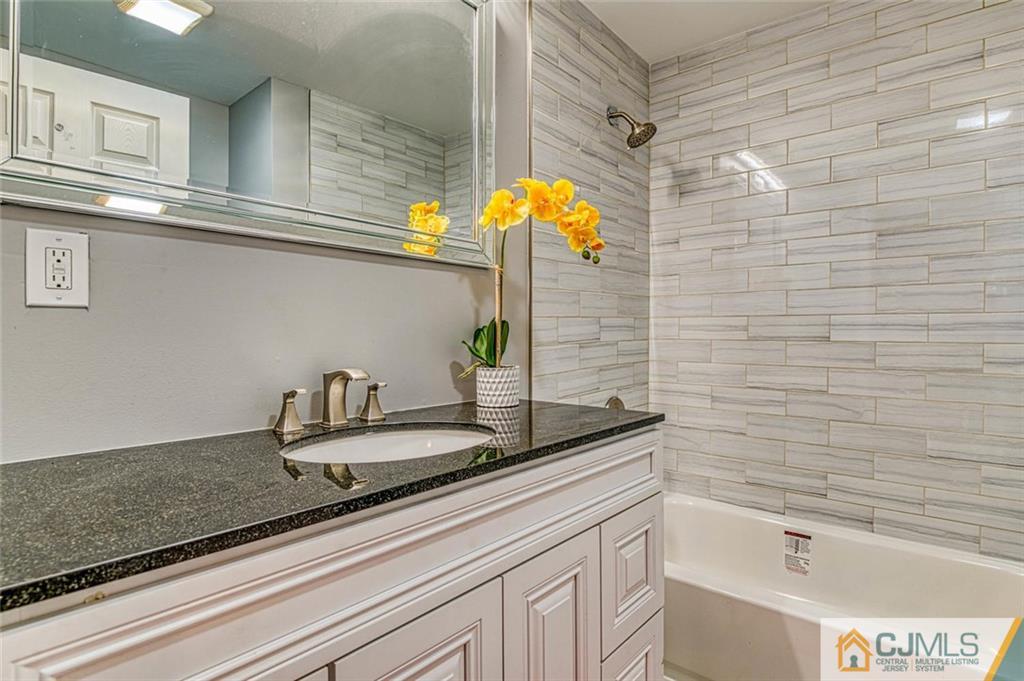 26 Colburn Road East Brunswick, NJ 08816 - Photo 12 of 22 a bathroom with a sink and a bathtub