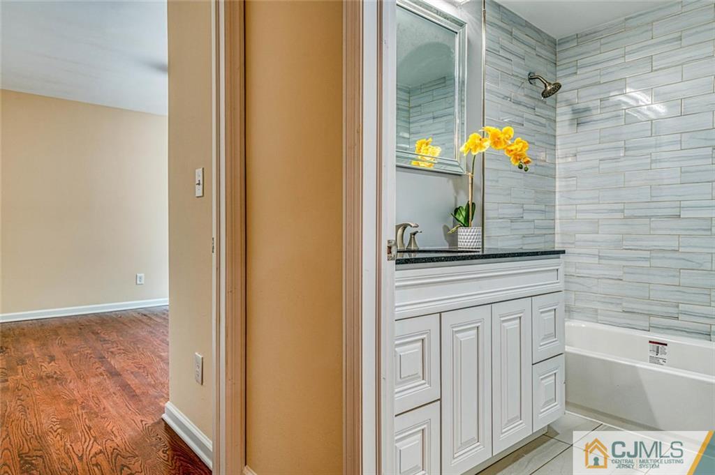 26 Colburn Road East Brunswick, NJ 08816 - Photo 13 of 22 a bathroom with a sink and a mirror