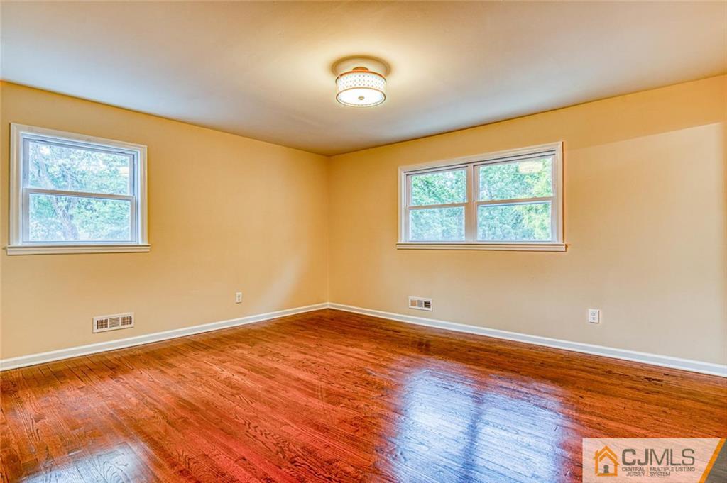 26 Colburn Road East Brunswick, NJ 08816 - Photo 14 of 22 a view of an empty room with wooden floor and a window