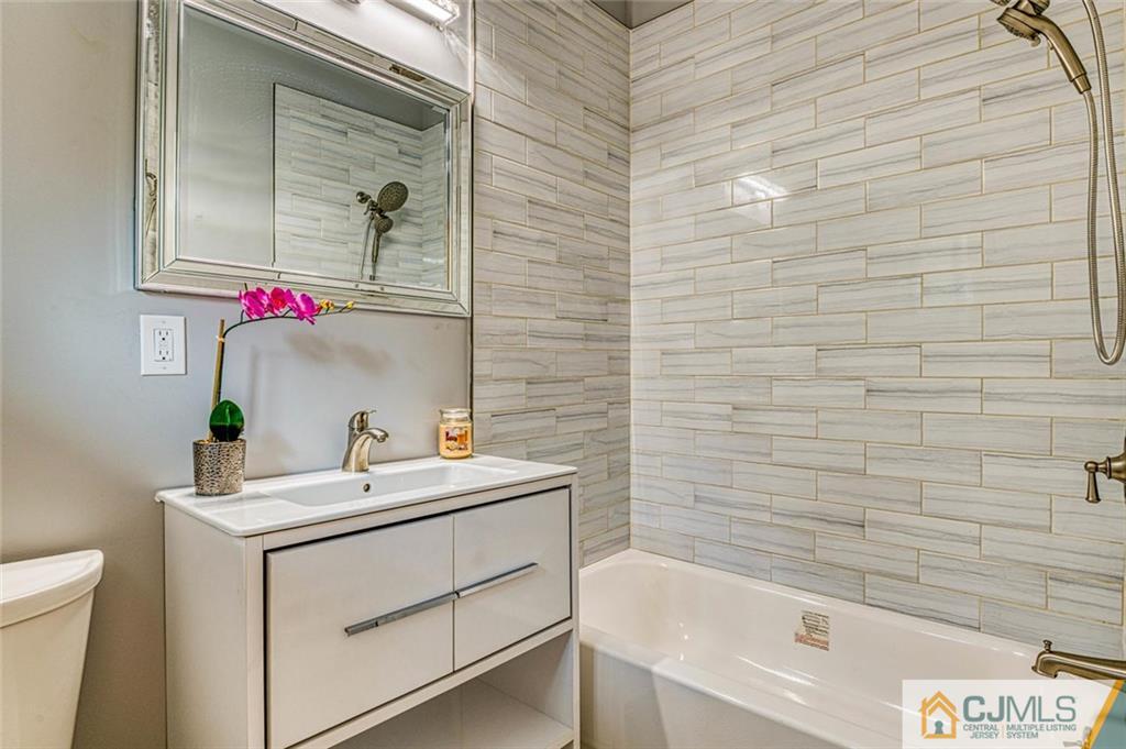 26 Colburn Road East Brunswick, NJ 08816 - Photo 15 of 22 a bathroom with a sink and a bathtub