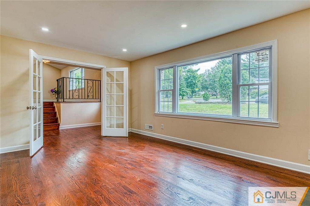 26 Colburn Road East Brunswick, NJ 08816 - Photo 19 of 22 a view of empty room with wooden floor and fireplace