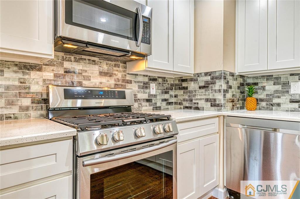 26 Colburn Road East Brunswick, NJ 08816 - Photo 7 of 22 a stove top oven sitting inside of a kitchen