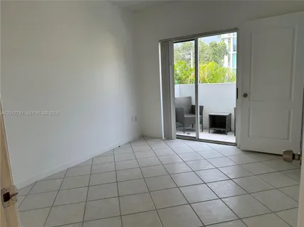 an empty room with a fireplace and a window