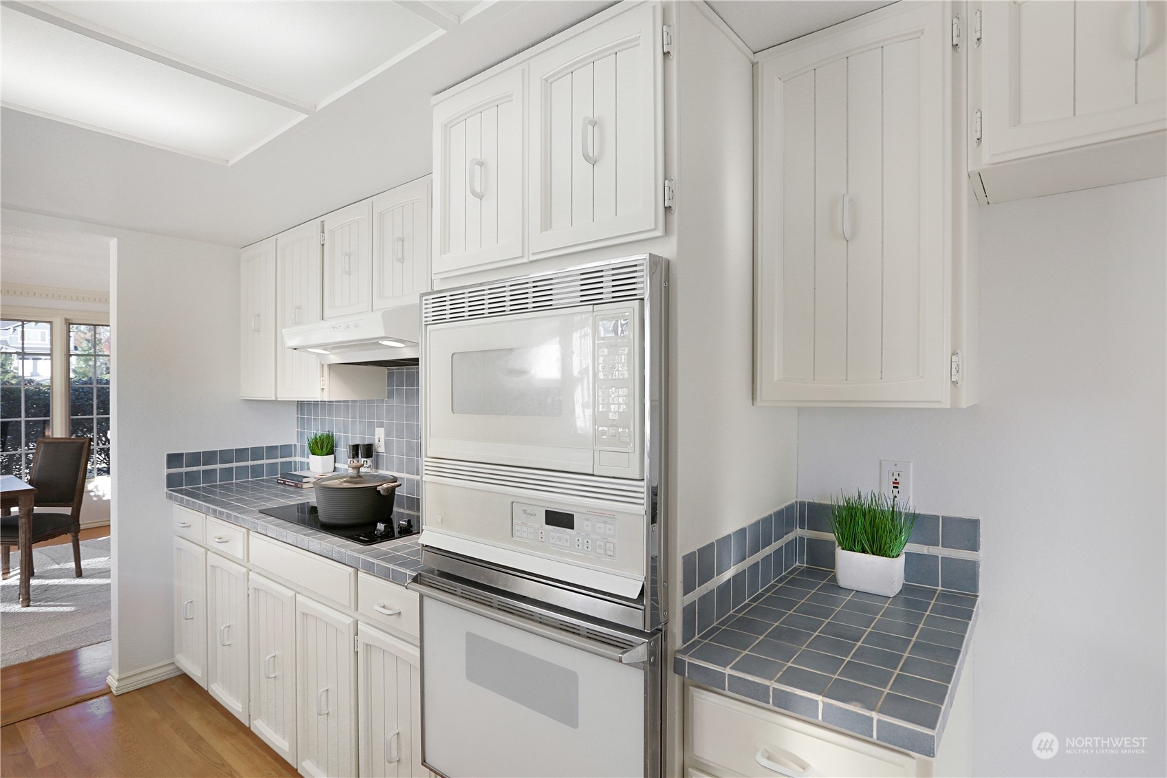 15203 Southeast 132nd Street Renton, WA 98059 - Photo 13 of 35 a kitchen with white cabinets and appliances
