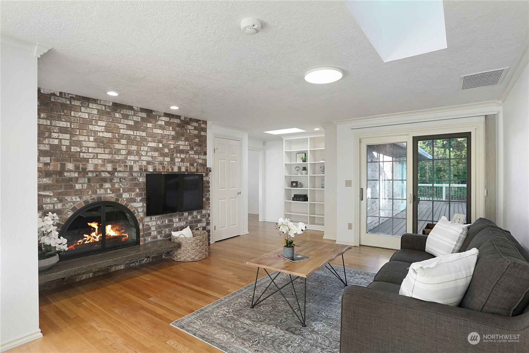 15203 Southeast 132nd Street Renton, WA 98059 - Photo 17 of 35 a living room with furniture a flat screen tv and a fireplace