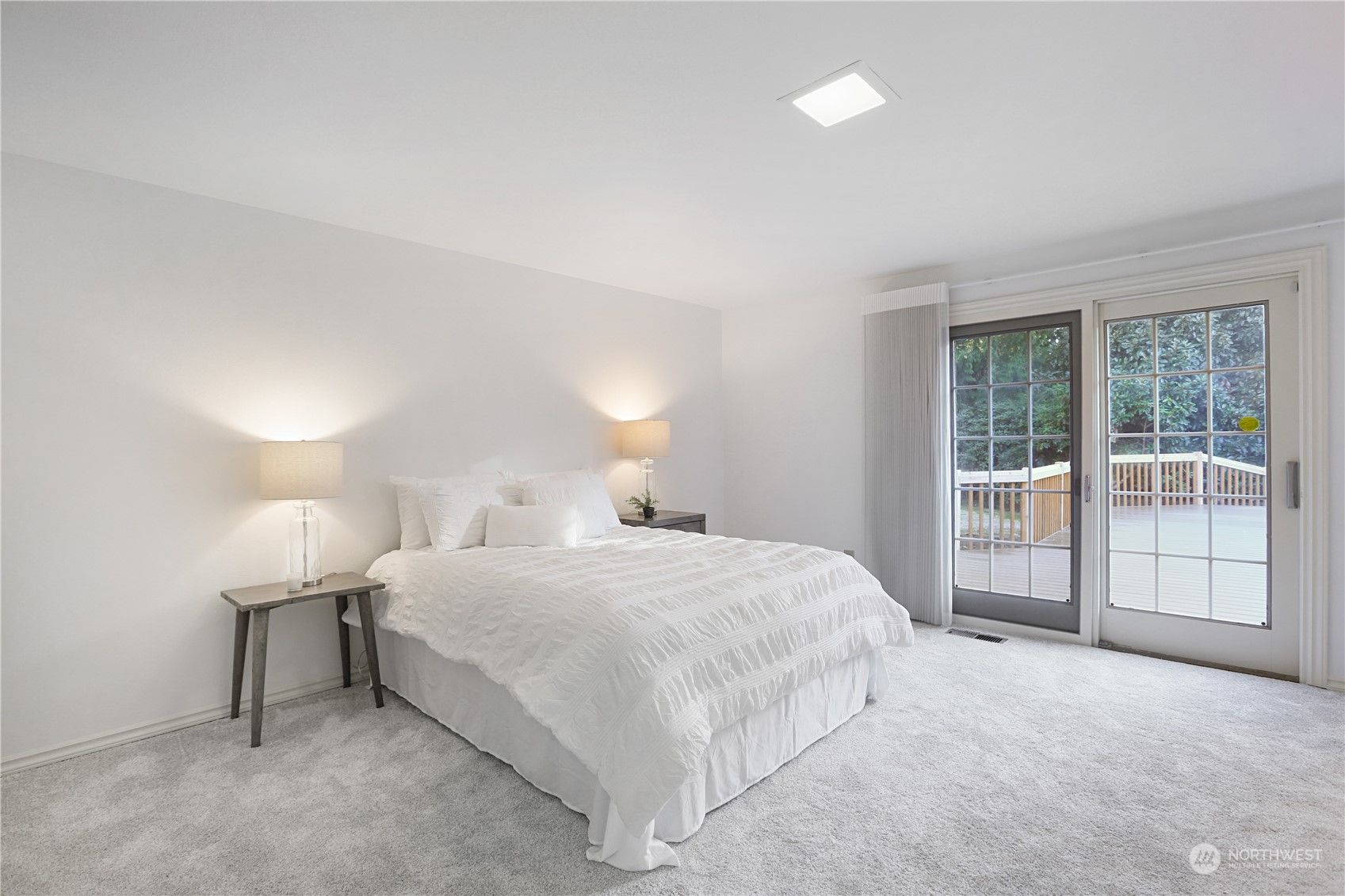15203 Southeast 132nd Street Renton, WA 98059 - Photo 19 of 35 a bedroom with a bed and a large window