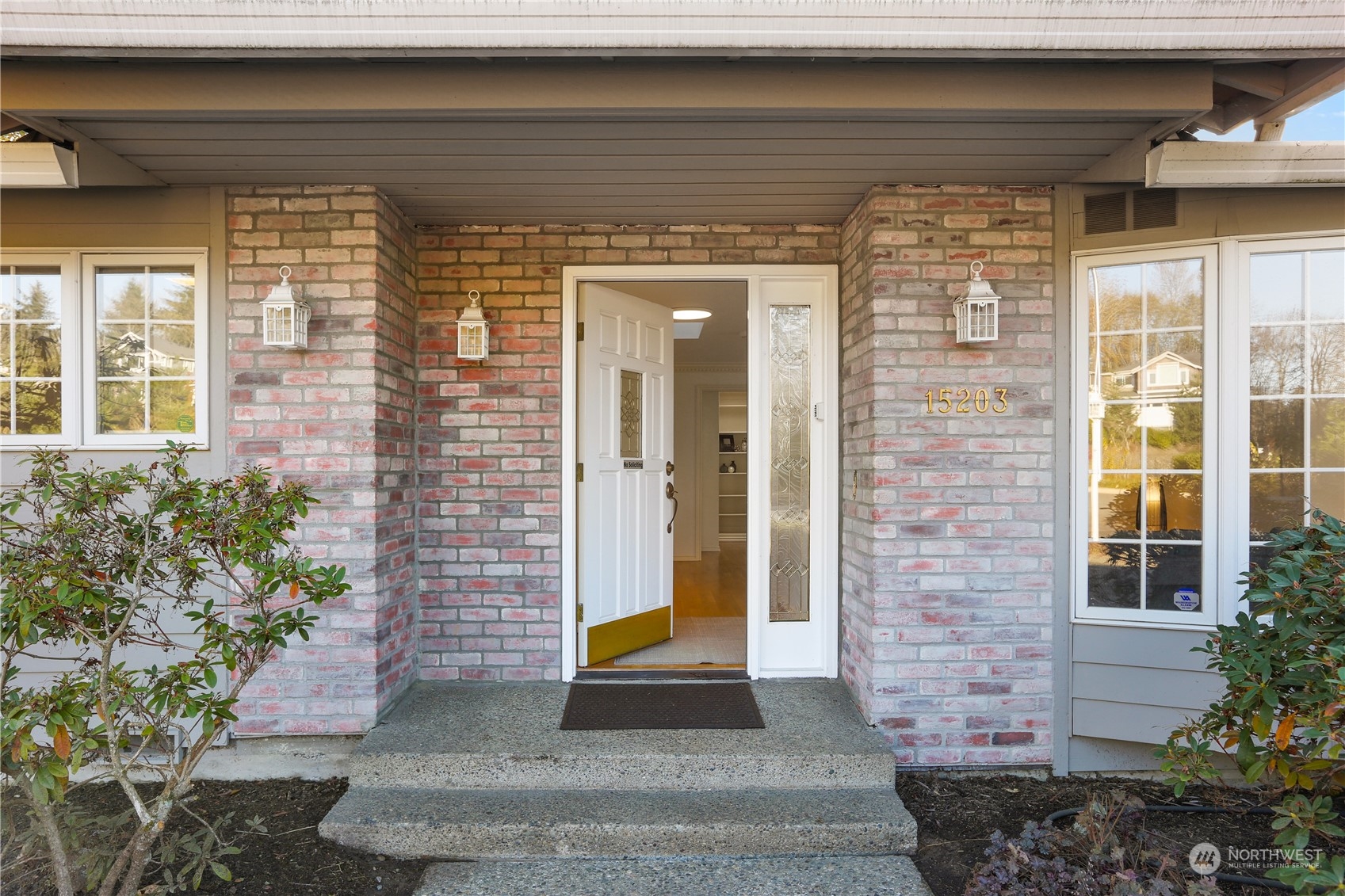 15203 Southeast 132nd Street Renton, WA 98059 - Photo 4 of 35 a front view of a house with a garden