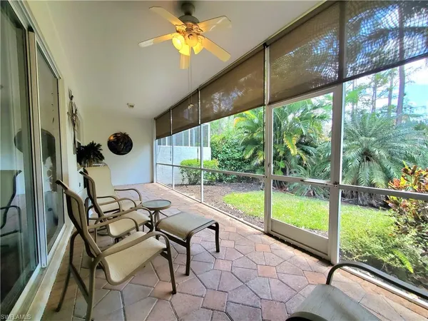 a dining room with furniture and a floor to ceiling window