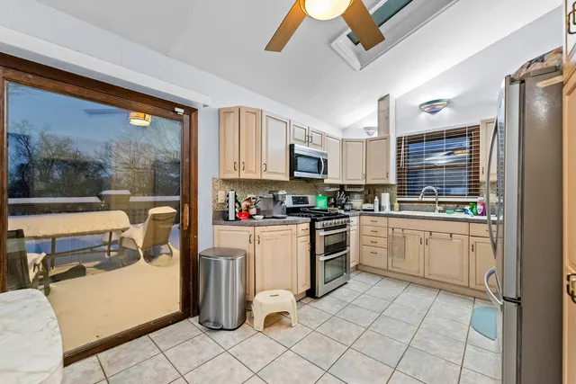 a kitchen with cabinets and chairs