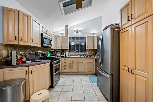 a kitchen with stainless steel appliances granite countertop a refrigerator sink and cabinets
