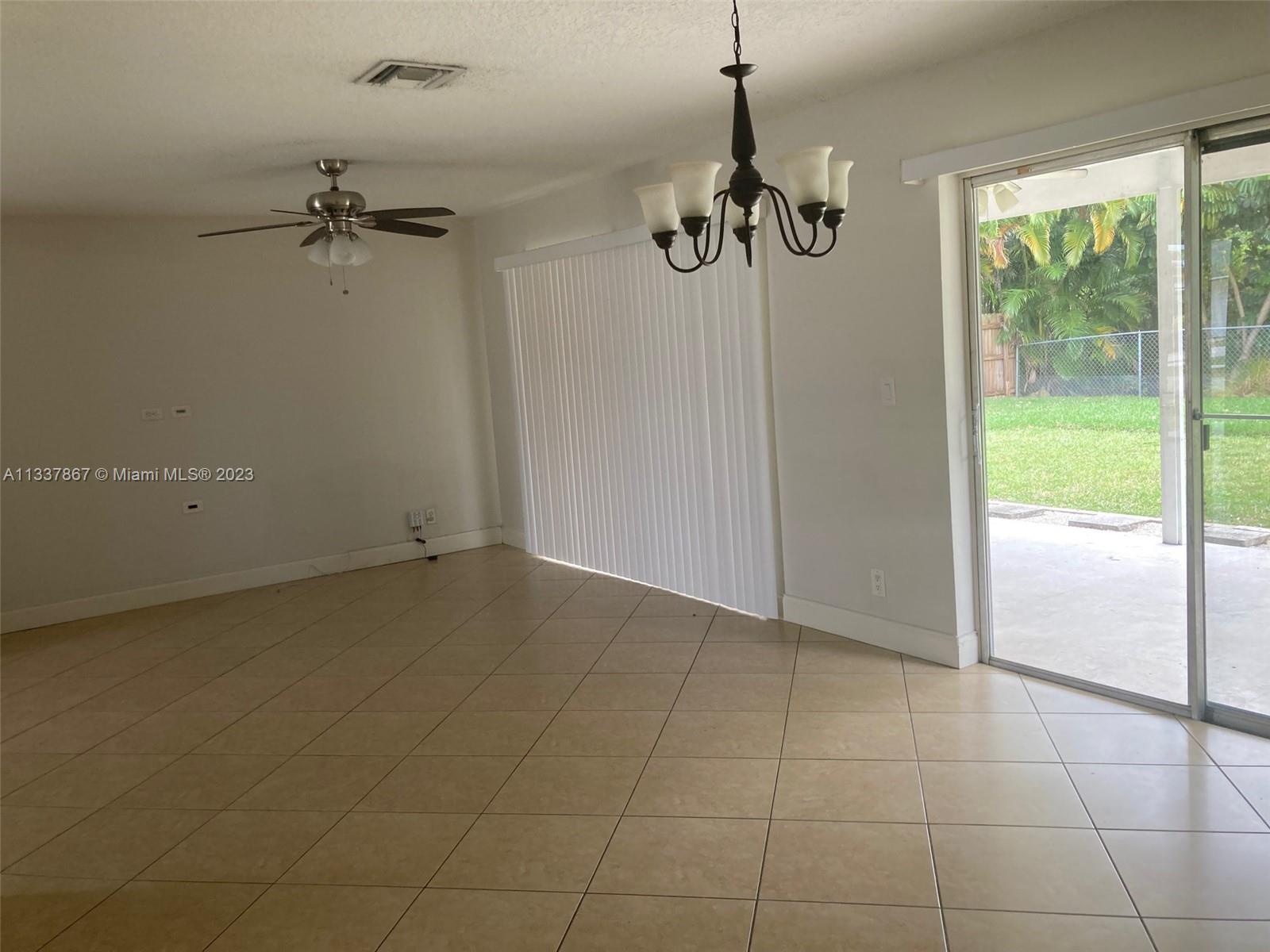 10374 Sleepy Brook Way Boca Raton, FL 33428 - Photo 3 of 12 en empty room with windows and outdoor view