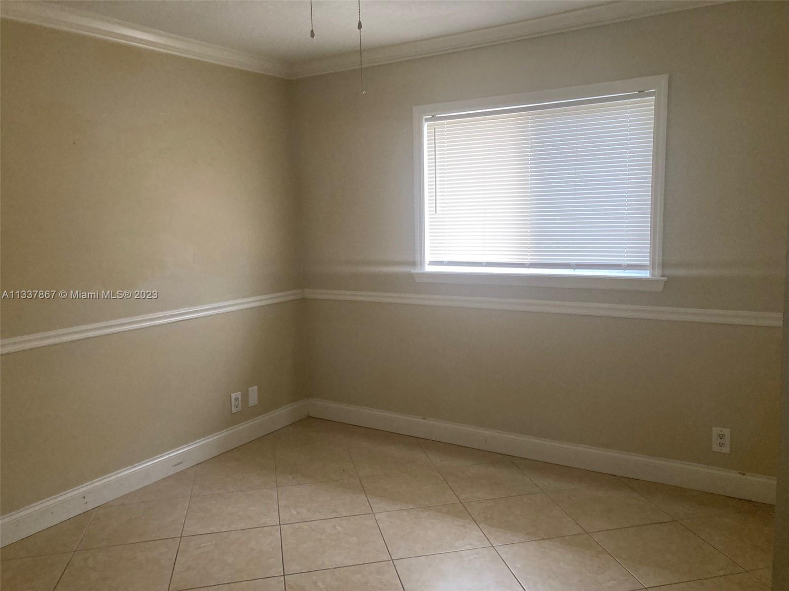 10374 Sleepy Brook Way Boca Raton, FL 33428 - Photo 7 of 12 an empty room with a window