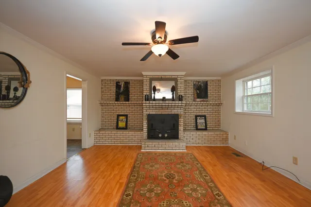 wooden floor in an empty room with a window