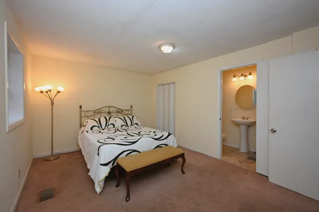 a bedroom with a bed and furniture