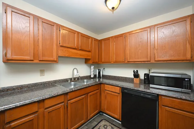 a kitchen with stainless steel appliances granite countertop a sink stove and microwave