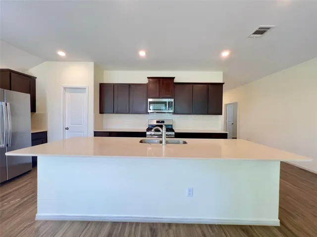 an empty room with a window and a ceiling fan