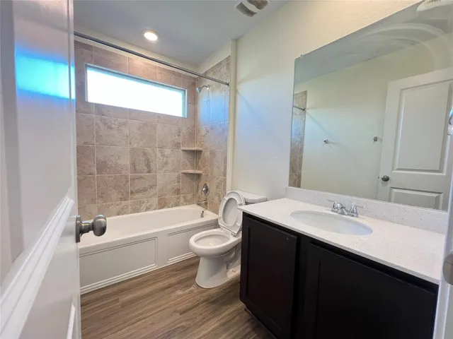 a kitchen with stainless steel appliances granite countertop a refrigerator a stove top oven and a sink with granite countertops